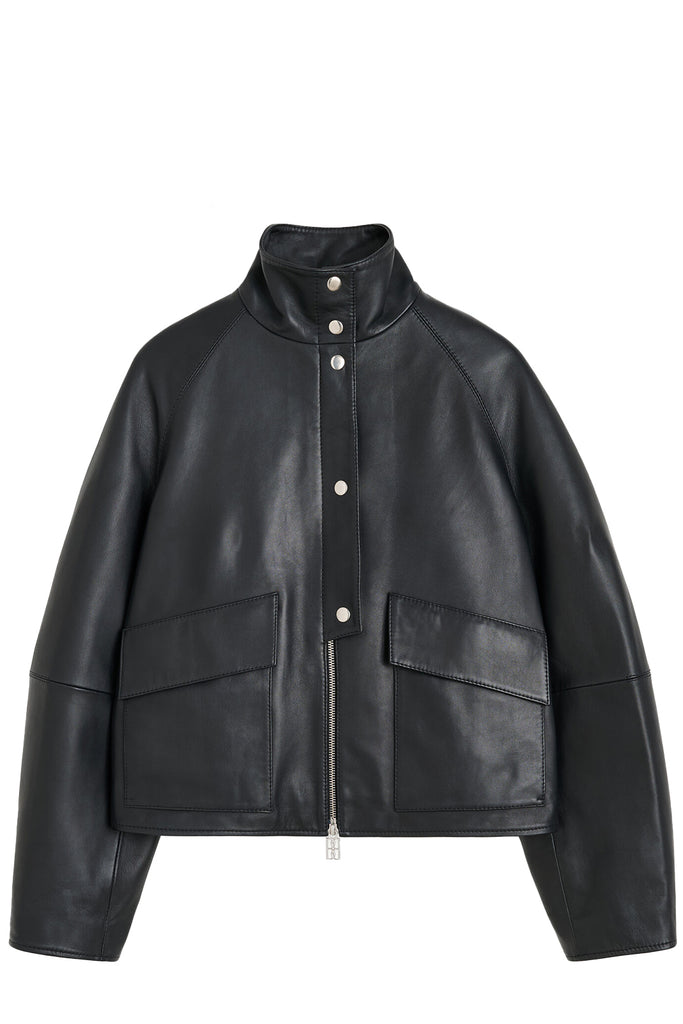 By Malene Birger jacket in black with patents, zipper and pockets, shown against a plain white background.