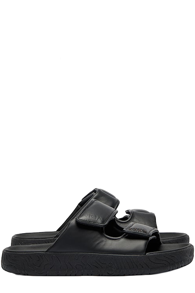 A pair of Veja sandals in black made from leather, shown against a plain white background.
