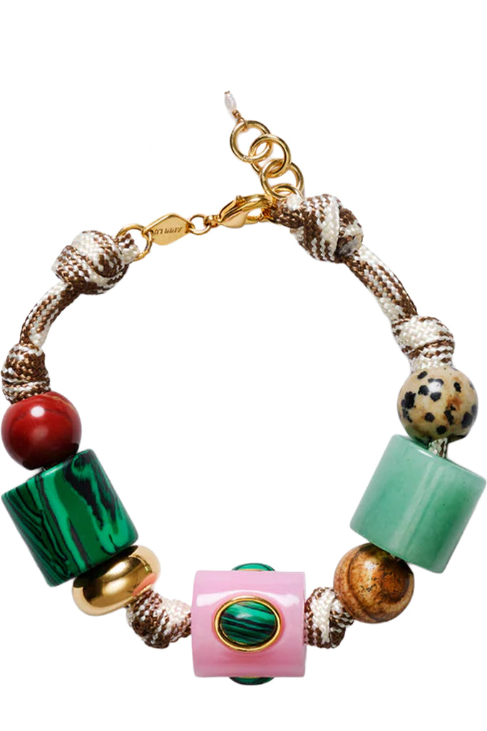 A beaded bracelet featuring a mix of colorful elements including a green malachite cube, a pink cylindrical bead with a green inlay, a light green cube, a red sphere, a spotted brown bead, and gold-toned metal accents, set against a plain white background.