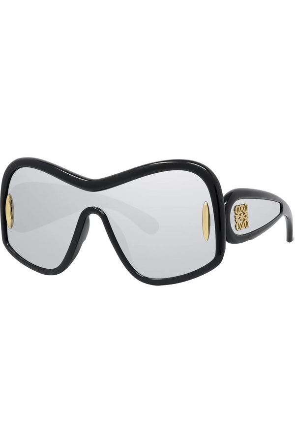 A pair of oversized shield-style sunglasses with a thick black frame, clear mirrored lenses, and gold-tone decorative details on the temples.