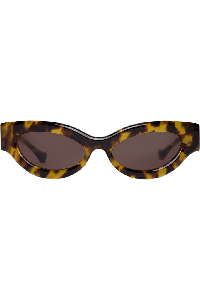 cat-eye sunglasses with a glossy tortoiseshell patterned frame and dark brown tinted lenses, shown against a plain white background.
