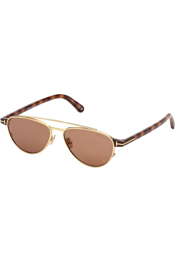 Rotated view of Tom Ford sunglasses in brown with tortoise and metal frame and gold T details, shown against a plaid white background.