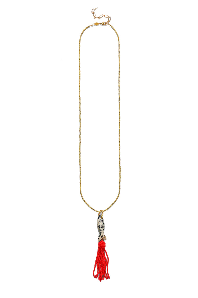 A long gold-toned beaded necklace with a silver-toned tassel charm and a bright red tassel, shown against a plain white background.