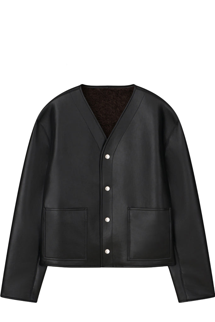 A black faux-leather cardigan jacket with a dark brown sherpa lining, featuring a button-up front and two front patch pockets, shown against a plain white background.