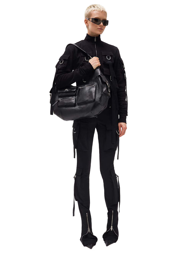 Model wearing the multi-pocket skinny slim-fit pants in black color from the brand BLUMARINE