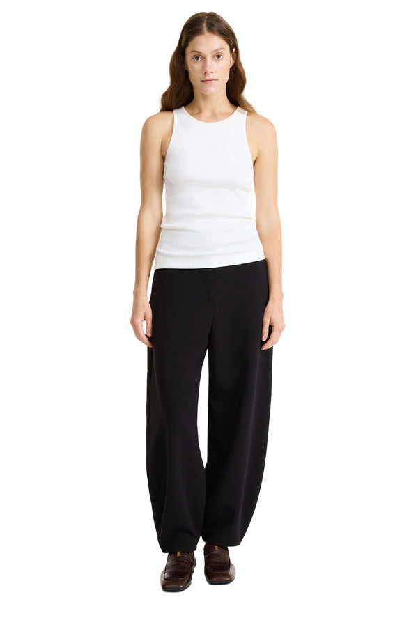 Model wearing the Carlien High-Waisted Trousers in black colour from the brand BY MALENE BIRGER