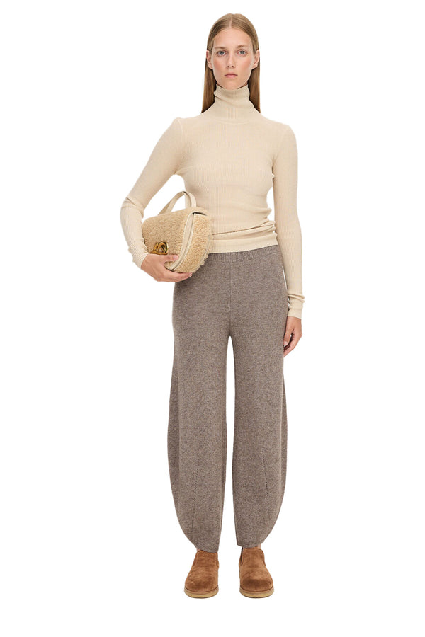 Model wearing the Tevah balloon wool-blend pants in beige color from the brand BY MALENE BIRGER