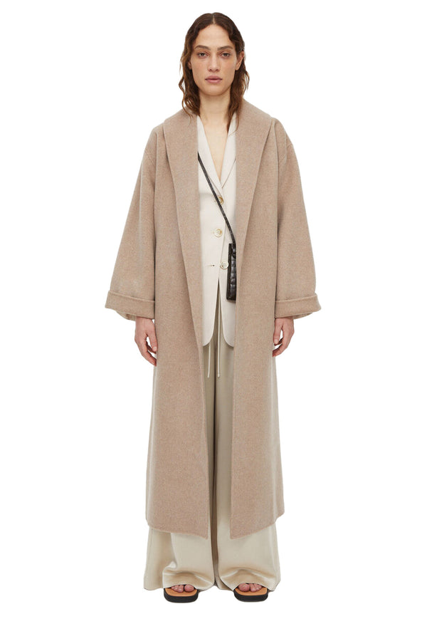 Model wearing the Trullem tie-knot wool coat in sesame color from the brand BY MALENE BIRGER