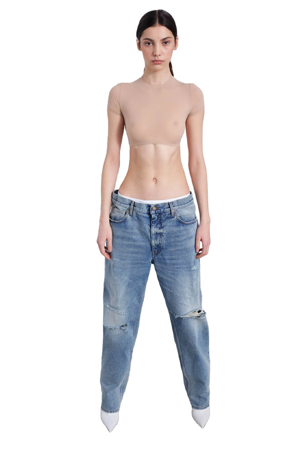 Model wearing the Jane elastic-waist ripped denim jeans in light wash color from the brand DARKPARK