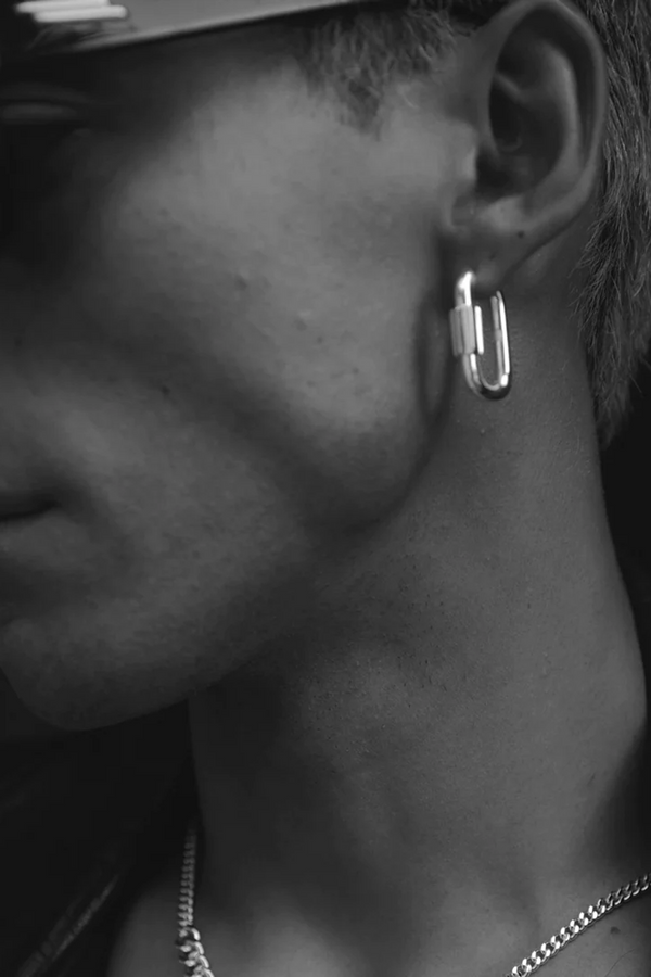 Model wearing the Disengage XL hoop earrings in silver colour from the brand F+H JEWELLERY