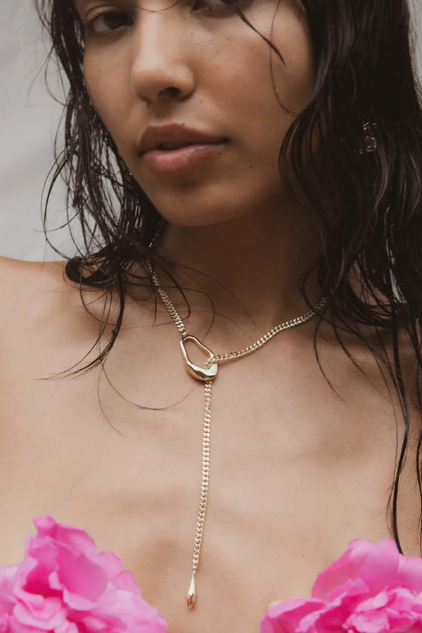 Model wearing the Lariat Drop necklace in gold colour from the brand F+H JEWELLERY