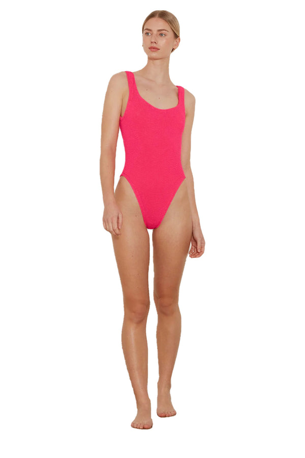 Model wearing the square-neck swimsuit in hot pink color from the brand HUNZA G