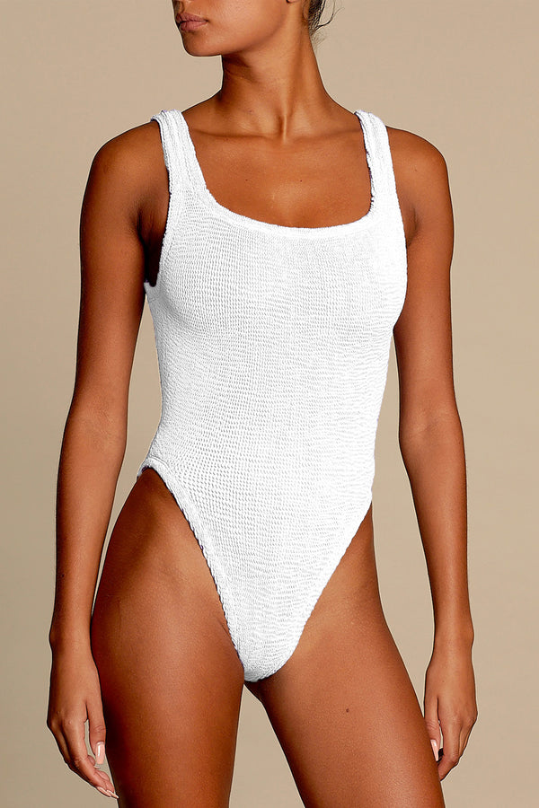 Model wearing the square-neck swimsuit in white color from the brand HUNZA G