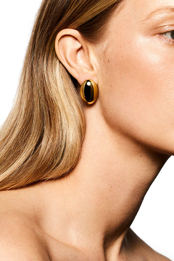 Model wearing the Camille stud earrings in gold colour from the brand LIÉ STUDIO
