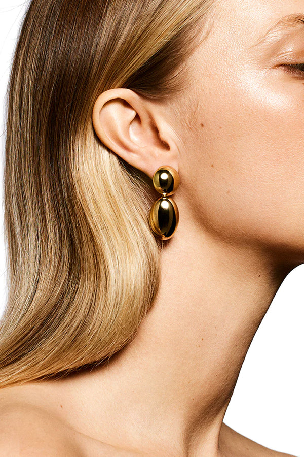 Model wearing the Klara stud earrings in gold colour from the brand LIÉ STUDIO