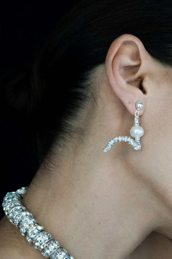 Model wearing the Tiny Snakes earrings in silver and pearl colours from the brand PEARL OCTOPUSS.Y