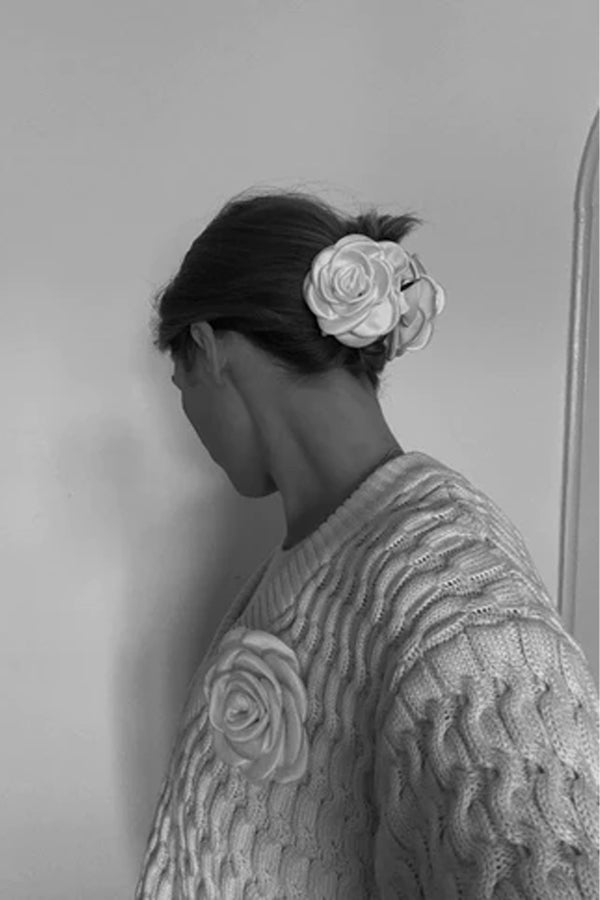 Model wearing the small satin rose claw clip in ivory colour from the brand PICO