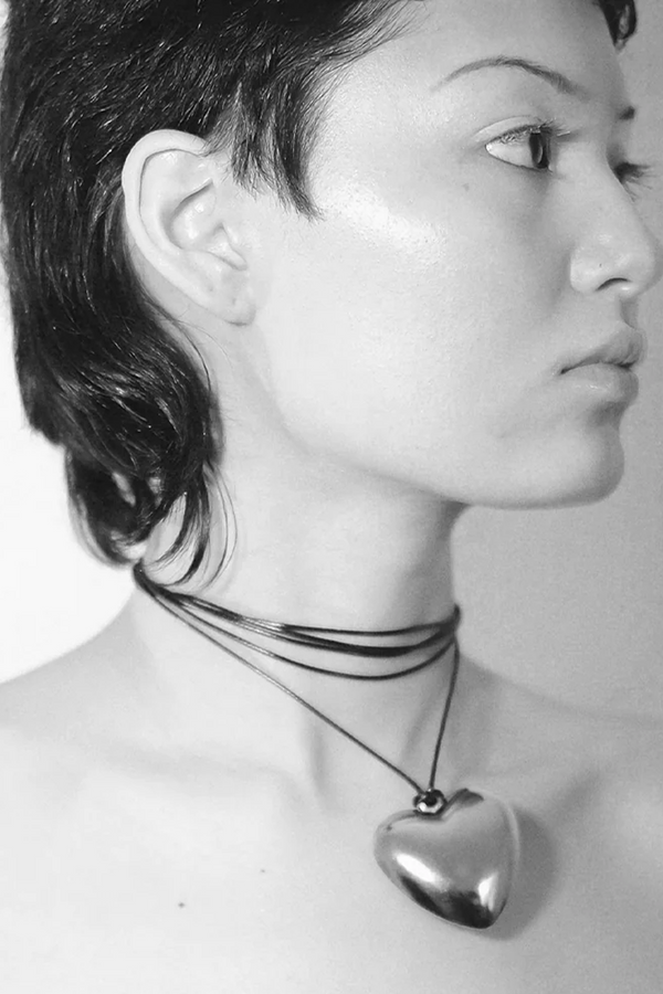 Model wearing the Spirit Small Heart necklace in silver and black colours from the brand THE GOOD STATEMENT