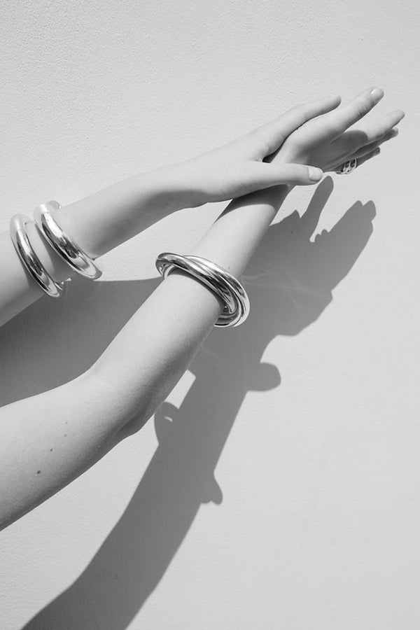 Model wearing the Stratus Bangle bracelet from the brand UNCOMMON MATTERS