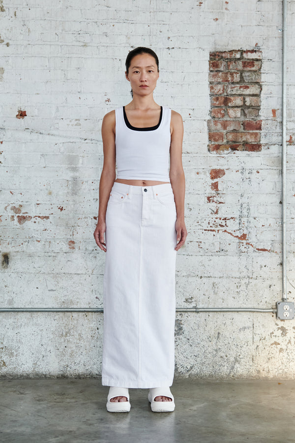 Model wearing the Back-Slit Denim Maxi Skirt in white colour from the brand Wardrobe.NYC