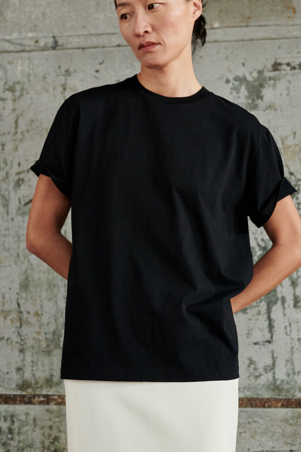Model wearing the Classic Boxy-Fit T-Shirt in black colour from the brand Wardrobe.NYC