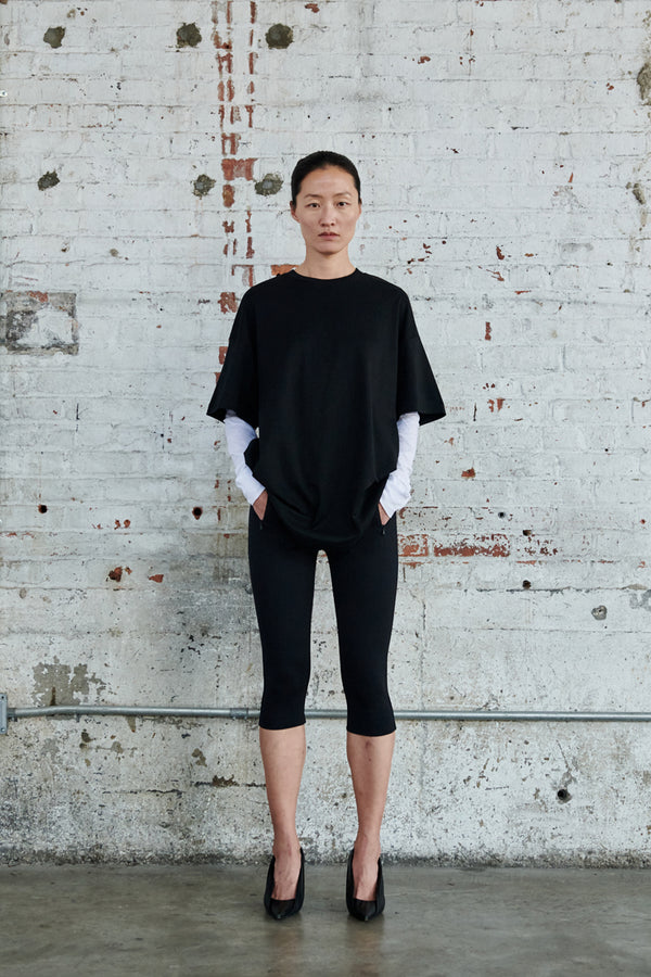 Model wearing the HB Oversize Elongated Boxy-Fit T-Shirt in black colour from the brand Wardrobe.NYC